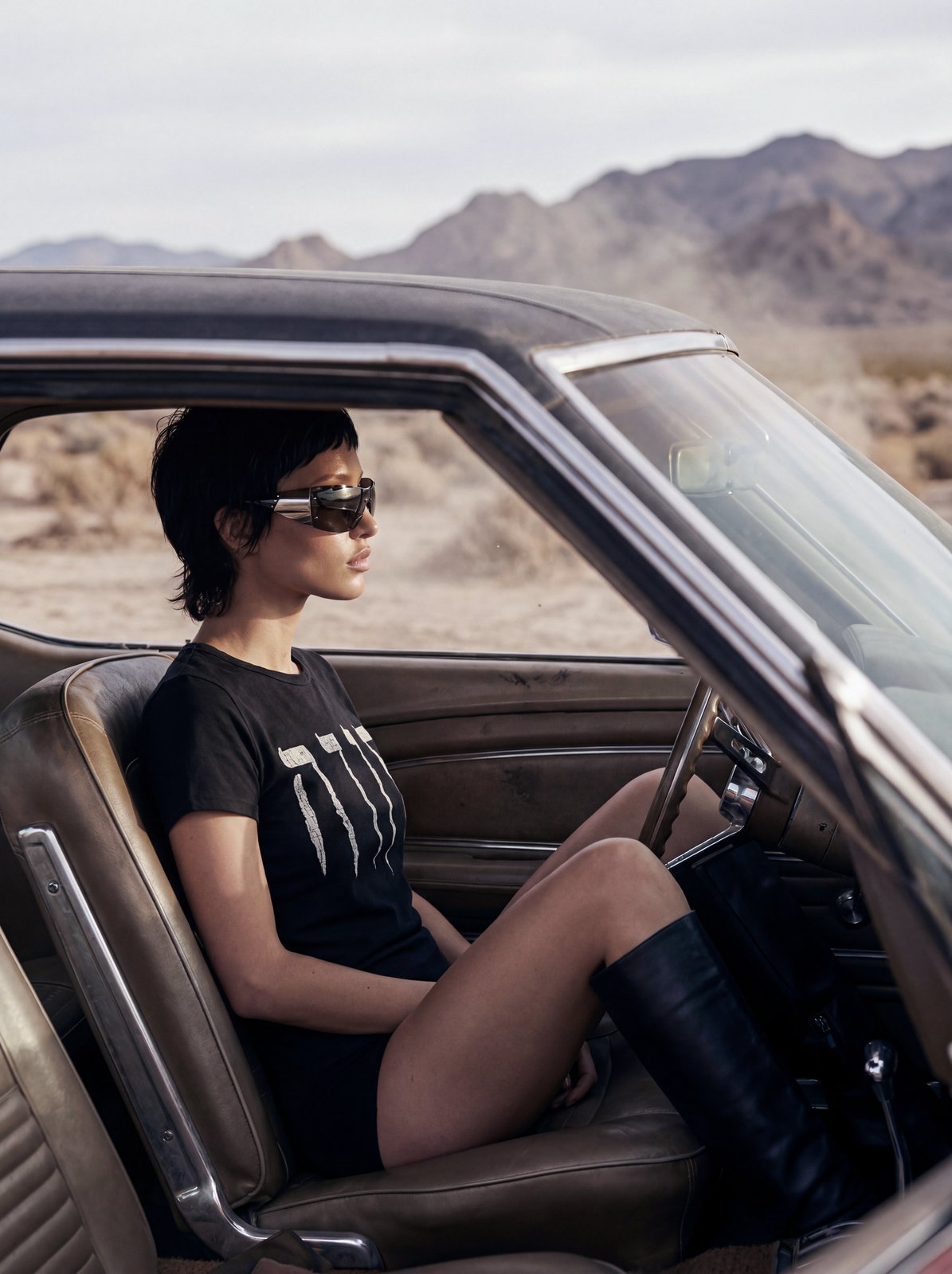 Desert editorial: model seated inside the car