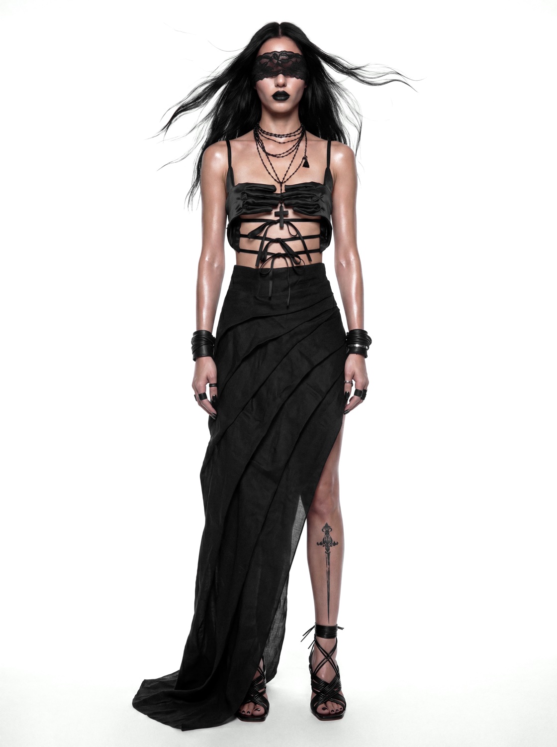 Editorial look in laced bralette and draped black skirt