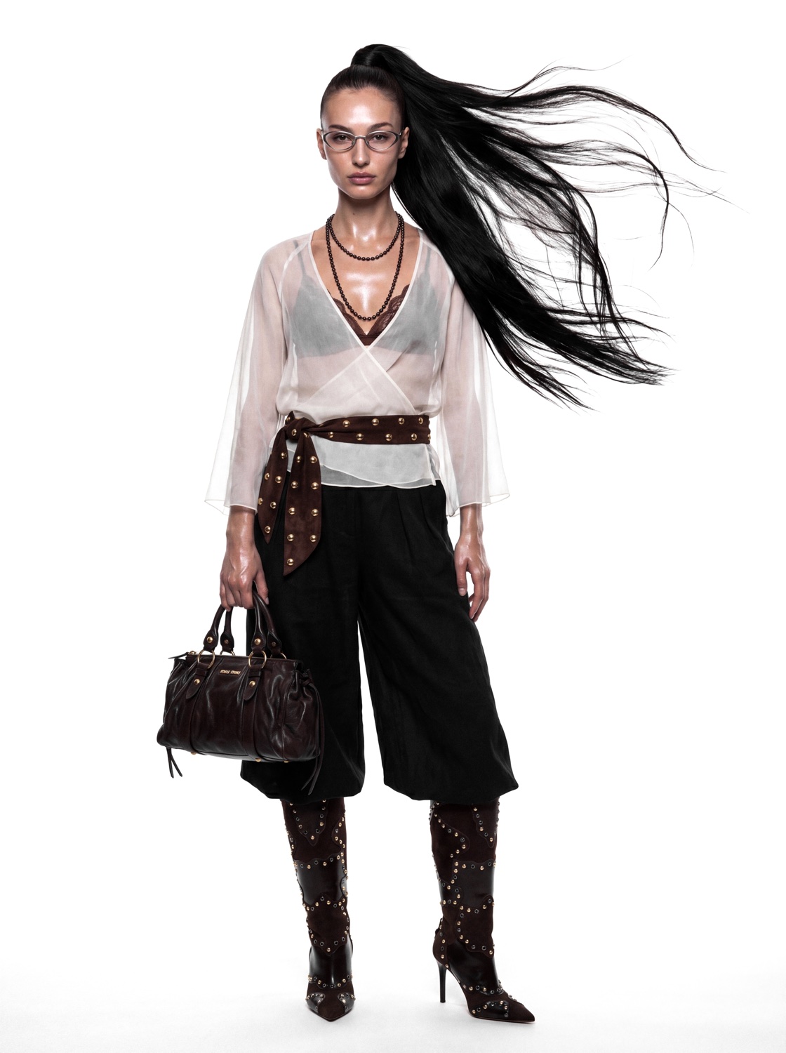 Editorial look in sheer blouse and black culottes